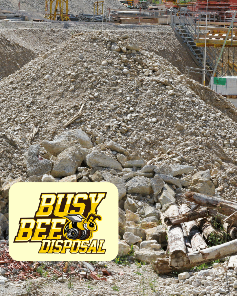 heavy rocks on construction site with Busy Bee Disposal logo