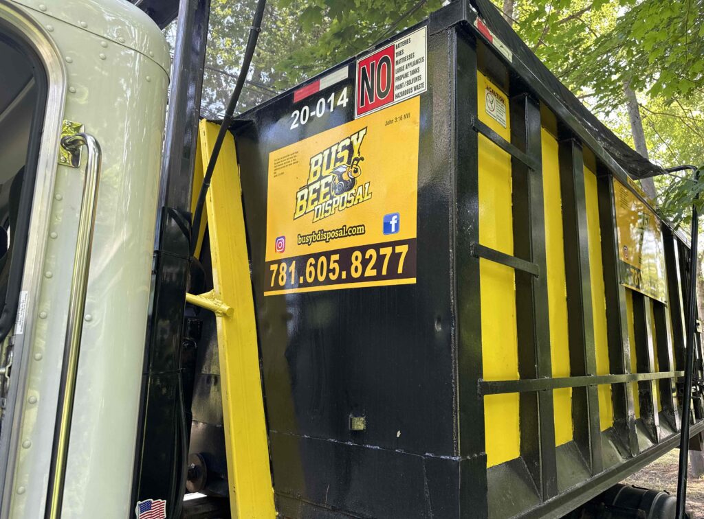 Busy Bee Disposal Dumpster on a truck