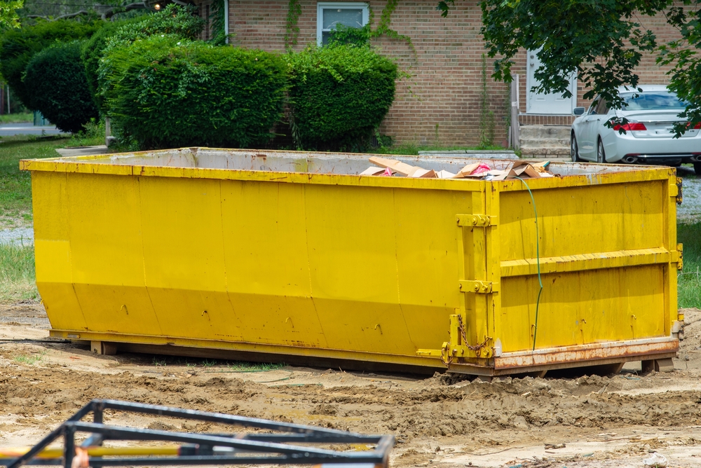 yellow 25-yard roll-off dumpster