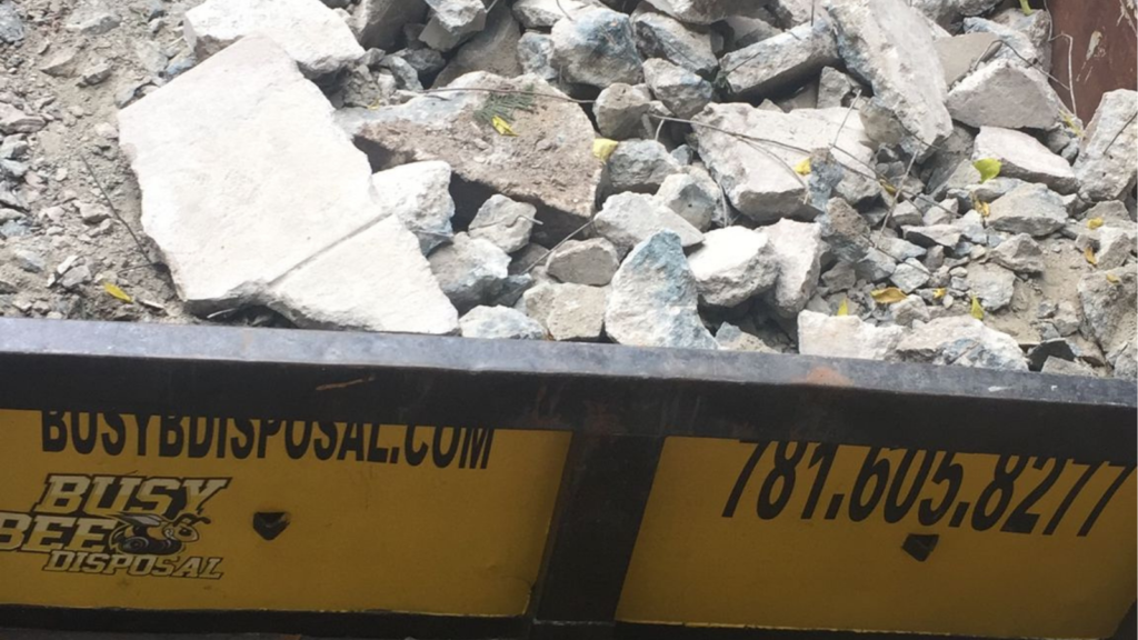 Busy Bee Disposal dumpster with heavy debris